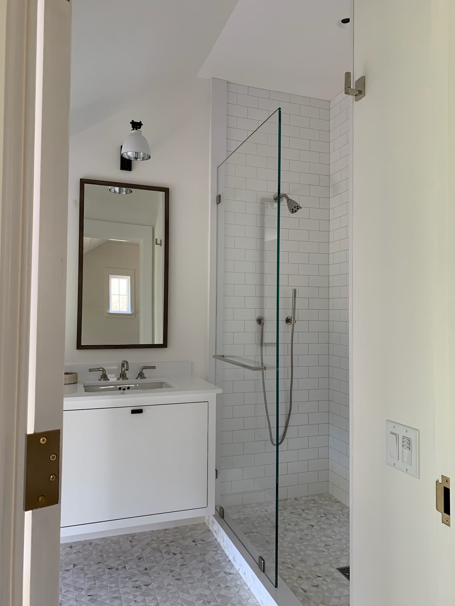 bathroom tile with white cabinets and mirror